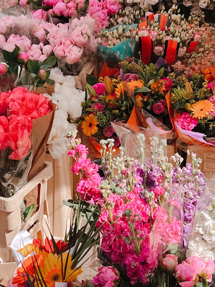 Colorful array of flowers at a sunny outdoor market, perfect for spring themes.